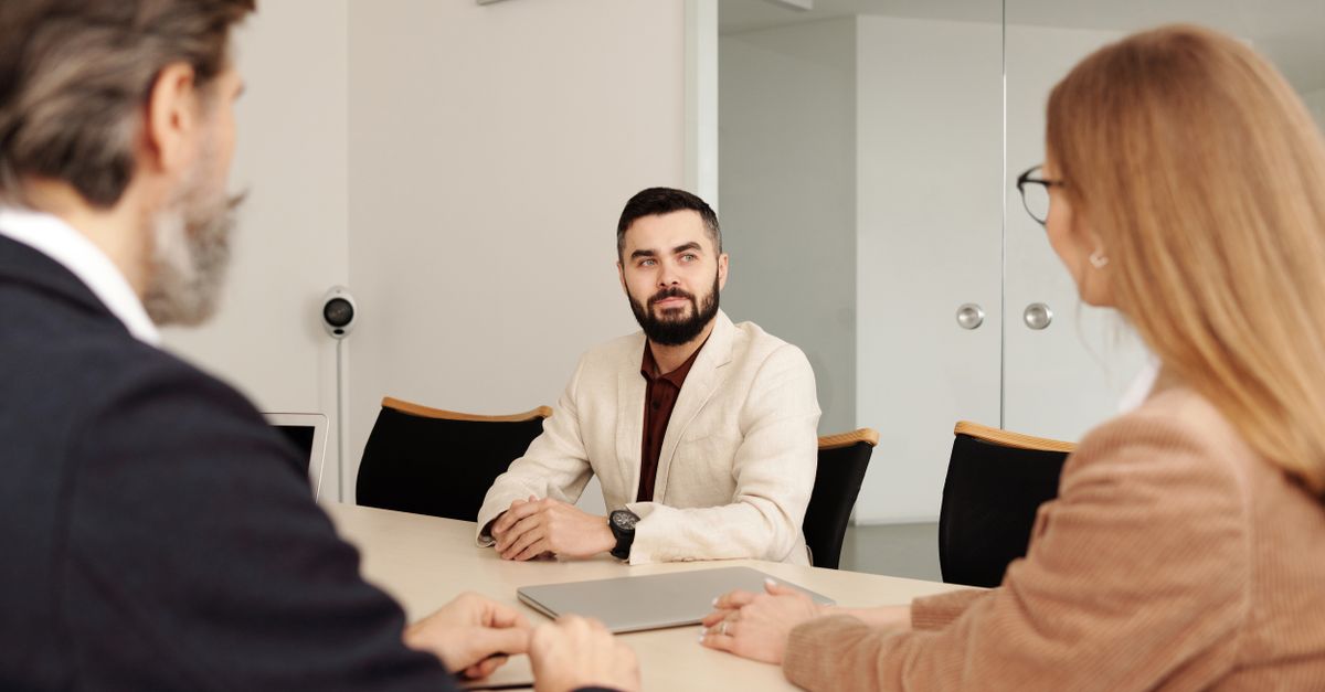 HR manager reviewing employee attendance and payroll on a laptop in an Indian office