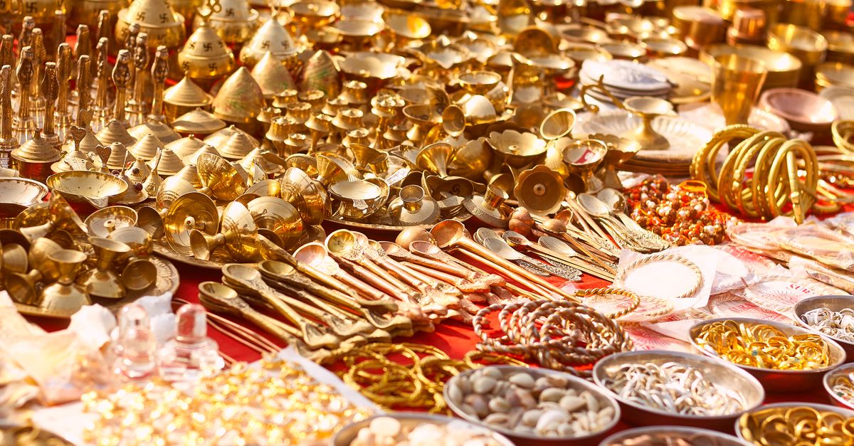 Gold jewellery on a weighing scale beside a billing screen representing jewellery shop software